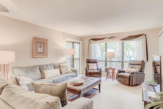 Dog-friendly condo with pool, central AC, & washer/dryer - quick walk to beach