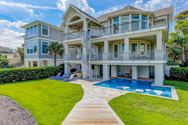 Stunning oceanfront home with pool, private boardwalk, decks, & elevator