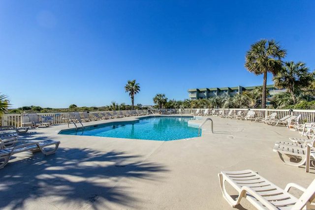 Oceanfront condo with water views, pool, balcony, & easy beach access