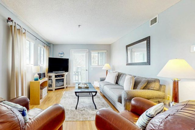 Updated coastal villa with pools, athletic courts, gym, smart TVs, AC, & W/D