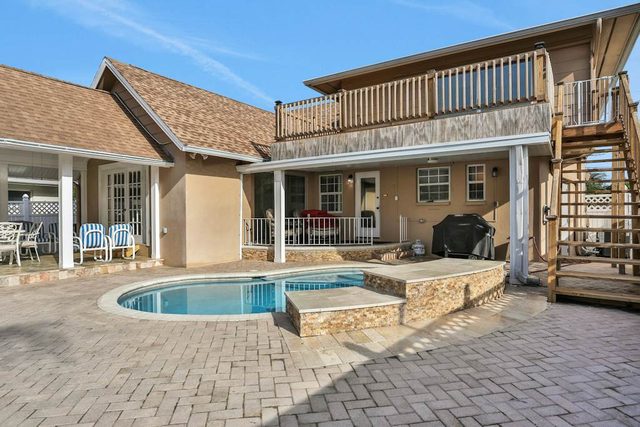Snowbird friendly elegant home with waterfront location pool grill fireplace