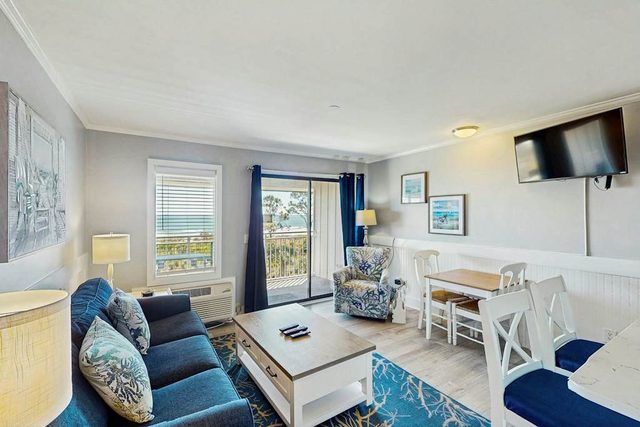 Beachfront escape with balcony, pool, beach access, WiFi, beach views, and AC